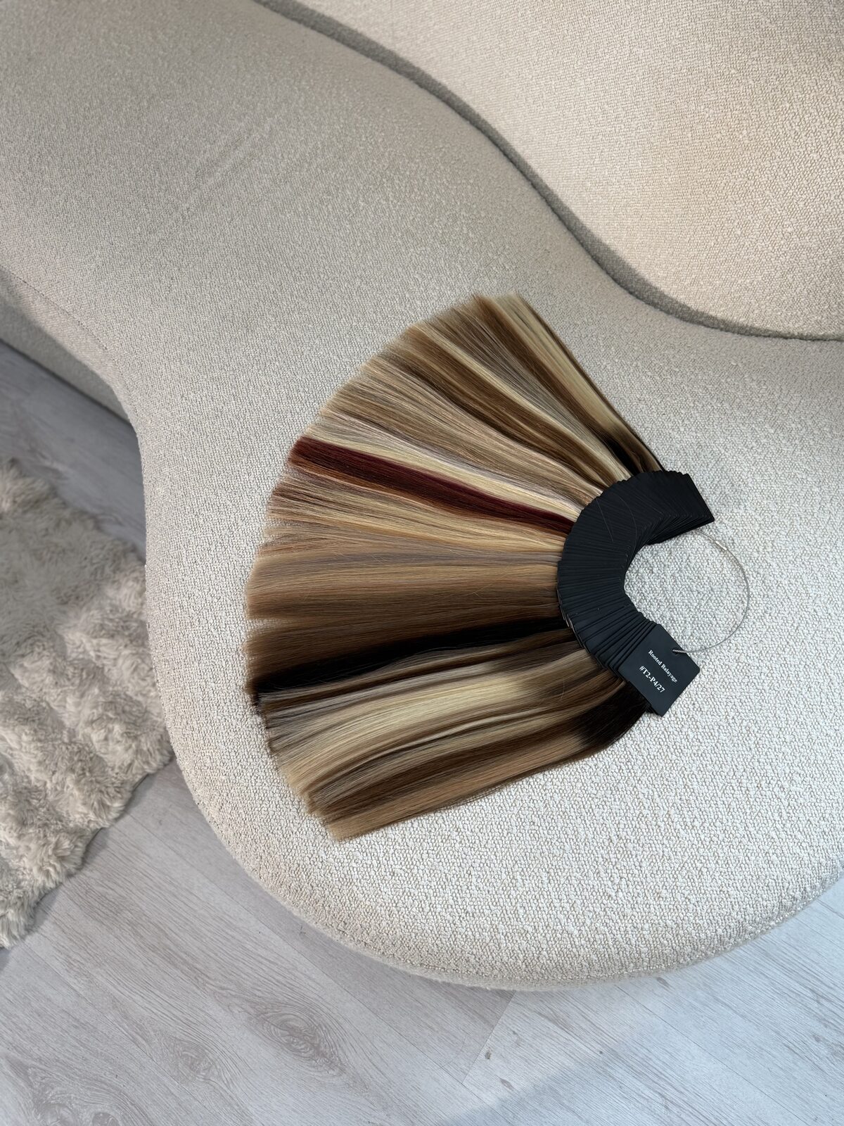 Nikki, The Hair Extension Coach, holding hair extensions in her salon