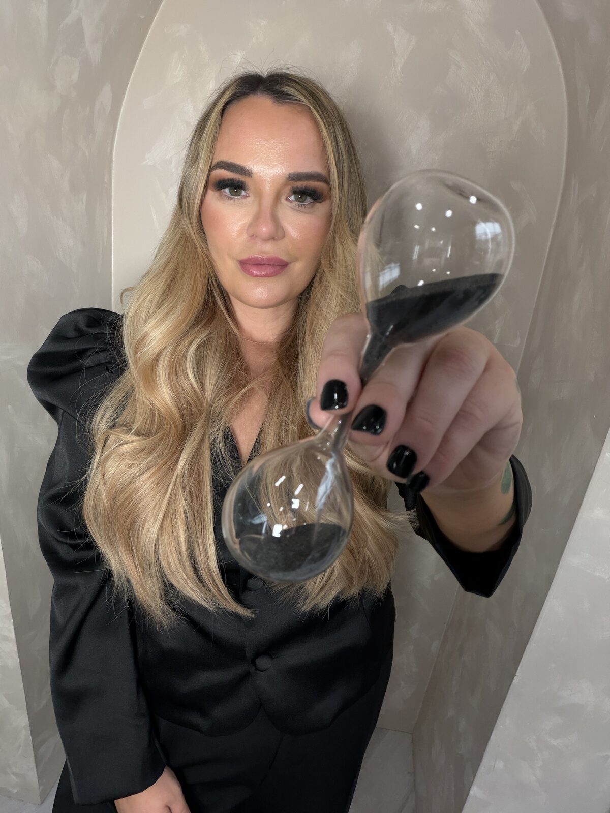 Nikki holding an hourglass